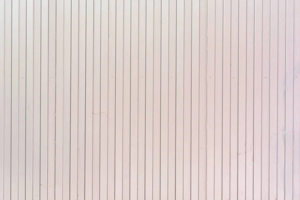 Фон вертикальних ліній. блідо-рожева стіна з незвичайних смуг, планки . — стокове фото