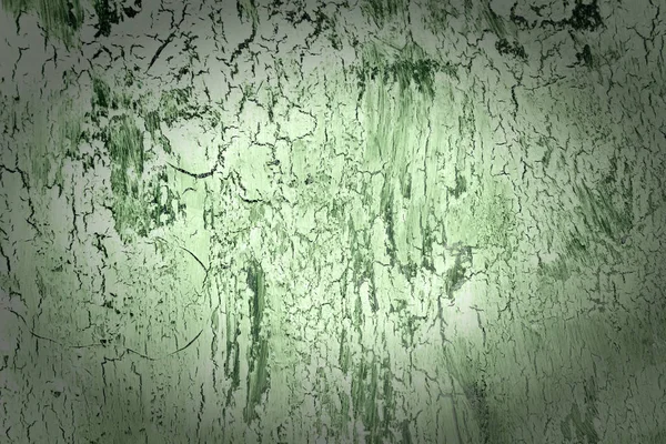 Fundo com tinta verde rachada e vinheta. Textura de revestimento áspero velho. Uma parede com um padrão abstrato incomum . — Fotografia de Stock