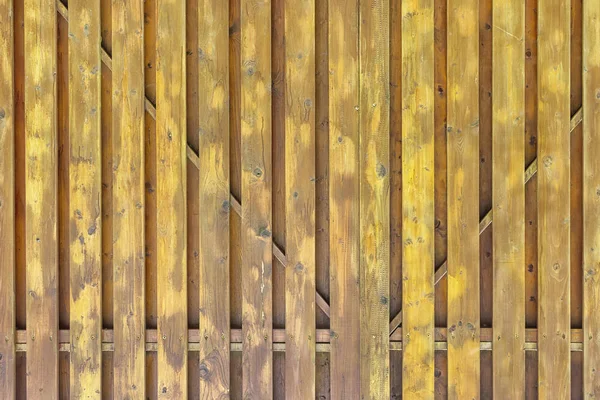 Фрагмент пофарбованих дерев'яних воріт. Структура дощок і боїв. Брудно жовтий об'ємний фон для компонування — стокове фото