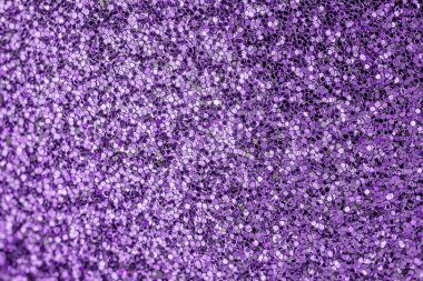 Bright shiny purple background for sites and layouts. The surface of many small sparkles, closeup. Selective focus clipart