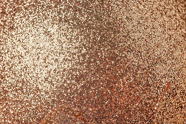 Shiny red-gold background. Small sparkles close-up. The basis for sites and layouts