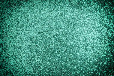 Bright photo of turquoise sparkles with vignette. Festive background for sites and layouts clipart