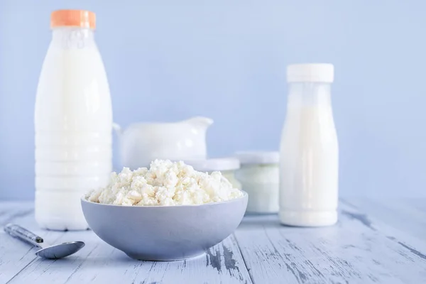 Set of healthy dairy products on a blue background. Kefir, milk, cottage cheese. Dietary foods