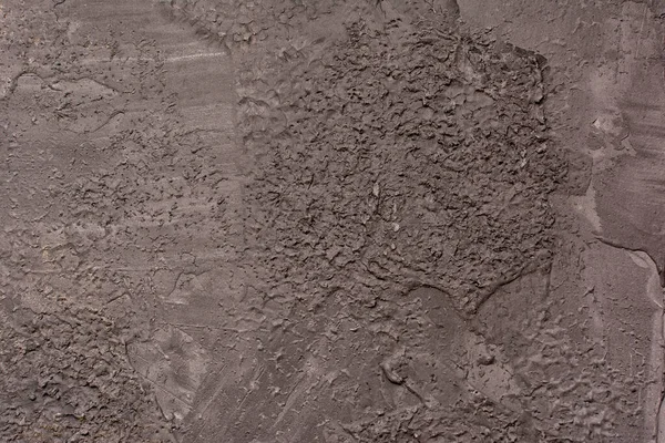 Pared oscura desigualmente enlucida. Fondo para sitios y diseños con textura de hormigón, la base para sitios y diseños — Foto de Stock