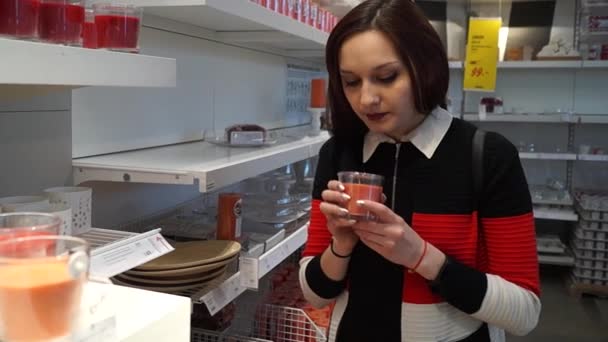 Girl Sniffs Scented Candles Chooses What She — Stock Video