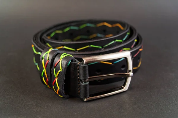 Genuine leather belt close up on black background — ストック写真