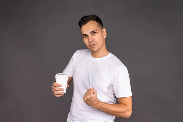 De man in het witte t-shirt is belast met de vrolijkheid van heerlijke koffie. — Stockfoto