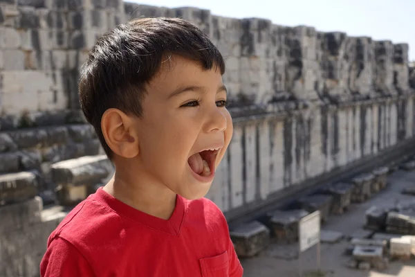 Portrait of smiling boy in the temple of Apollo. — Stock Photo, Image