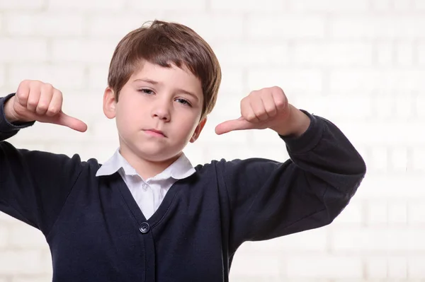 Picture of primary school boy with thumbs middle — Stock Photo, Image