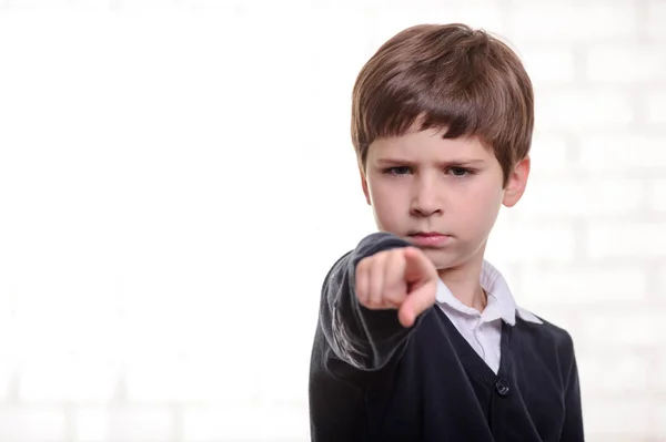 Serious primary school boy points to you with his finger — Stock Photo, Image