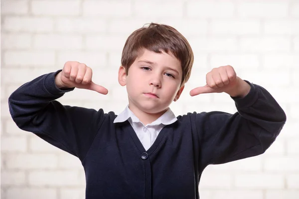 Picture of primary school boy with thumbs middle — Stock Photo, Image