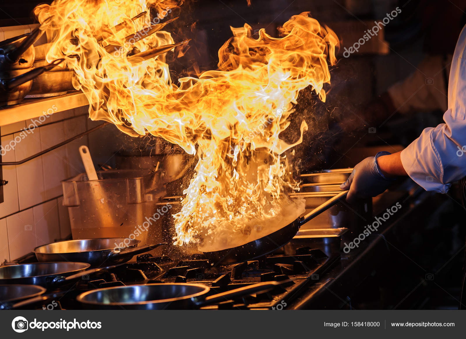 Chef is stirring vegetables in wok on open fire. — Stock Photo © Manowar1973 158418000