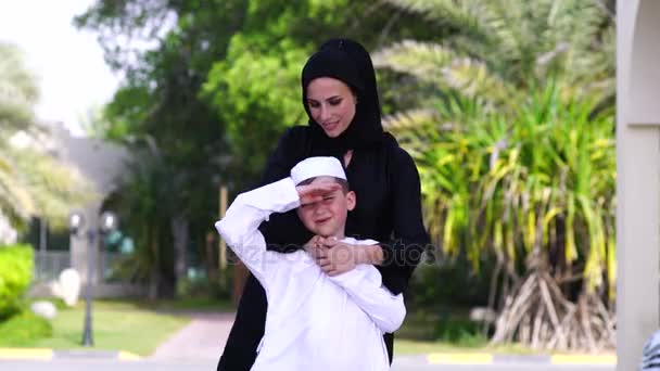 Arabic mother and son play together outdoors. — Stock Video