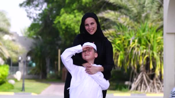 Arabic mother and son play together outdoors — Stock Video