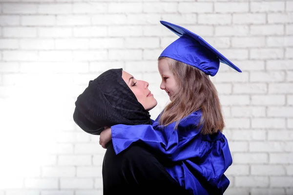 Arabic mother posing with graduated daughter. — Stock Photo, Image