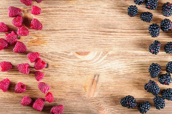 Various fresh summer berries, raspberries and black berries in old wooden background — Stock Photo, Image