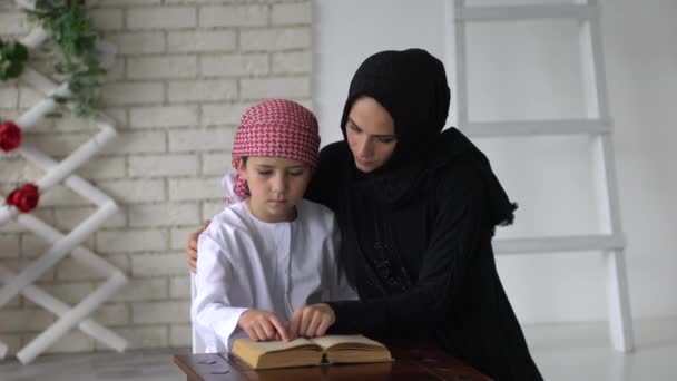 阿拉伯语的母亲和儿子在室内阅读. — 图库视频影像