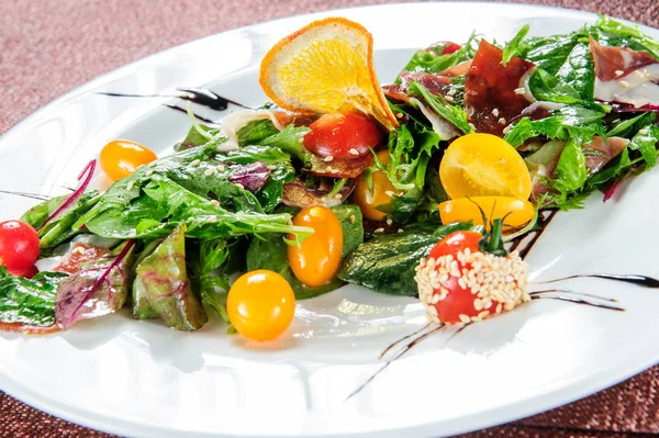 Grüner Salat garniert mit gelben Tomaten. — Stockfoto