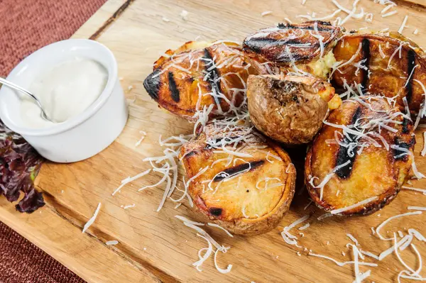 Baked spicy potatoes in baking dish. — Stock Photo, Image