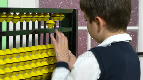 Pupil dressed up as teacher holding abacus in a classroom — Stock Video