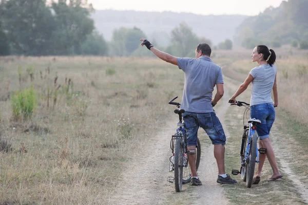 시골에서 자전거와 함께 행복 한 젊은 커플. — 스톡 사진