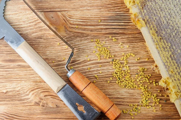 Miel fresca en el peine y las herramientas del apicultor sobre un fondo vudú. Plano y vista superior —  Fotos de Stock