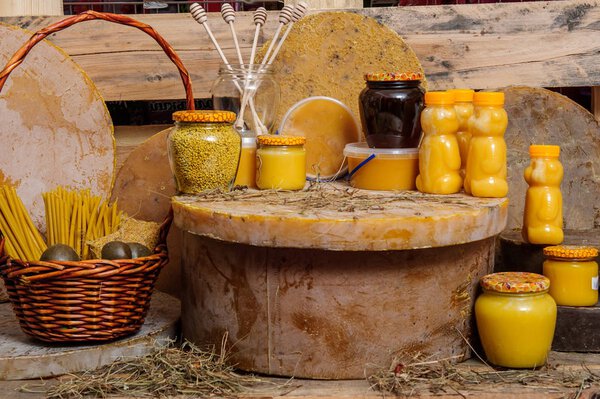 Various bee products - honeycomb bowl with pollen, honey, honey with nuts soap and wax and propolis. Products of livelihoods of bees. Wax. Cells. Honey. Pollen. Beekeeping.