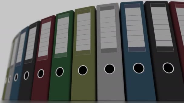 Verschiedene Büroordner rotieren, Weitwinkelaufnahme, flacher Fokus. 4k nahtlose loopable Animation — Stockvideo