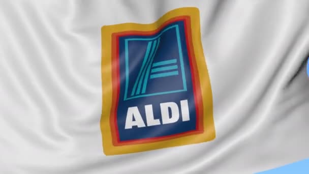 Primer plano de la bandera ondeante con el logotipo de Aldi, lazo sin costuras, fondo azul. Animación editorial. 4K ProRes, alfa — Vídeos de Stock