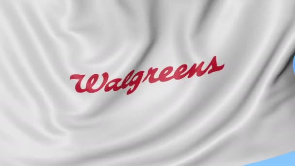 Primer plano de la bandera ondeante con el logotipo de Walgreens, lazo sin costuras, fondo azul. Animación editorial. 4K ProRes, alfa — Vídeos de Stock