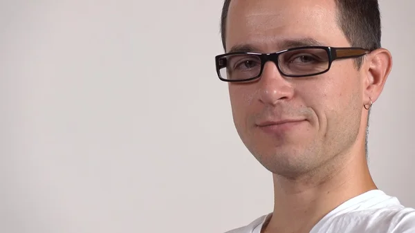 Portrait of a programmer in black rim glasses against gray background — Stock Photo, Image