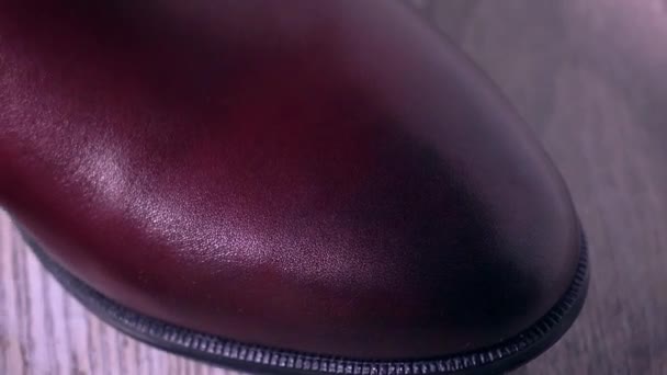 Expensive dark red leather mens footwear 4K pan long shot — Stock Video