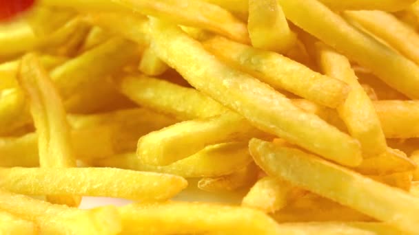Adding tomato ketchup to french fries. Popular fast food, deep fried potato chips. Super slow motion macro video — ストック動画