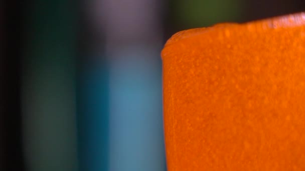 Pouring orange bath foam. 4K close up slow motion shot — Stock video