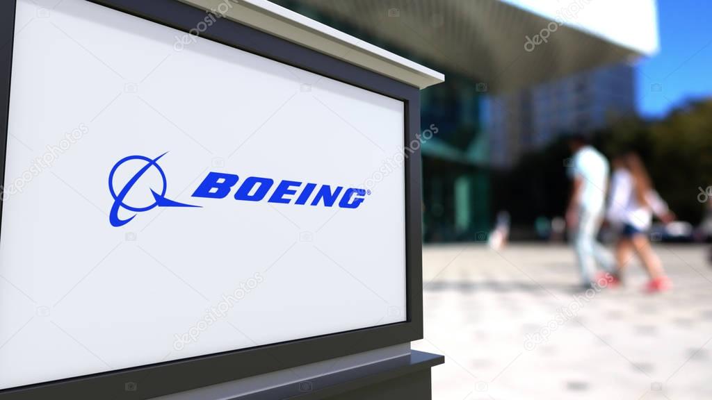 Street signage board with Boeing Company logo. Blurred office center and walking people background. Editorial 3D rendering United States