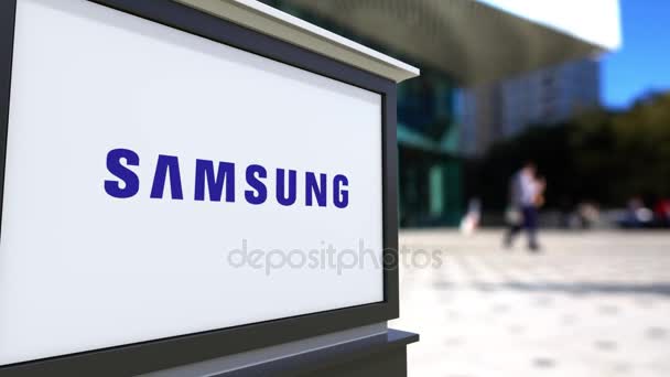 Street signage board with Samsung logo. Blurred office center and walking people background. Editorial 4K 3D rendering — Stock Video