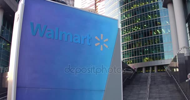 Cartello stradale con logo Walmart. Moderno centro direzionale grattacielo e scale di sfondo. Rendering 3D 4K editoriale — Video Stock