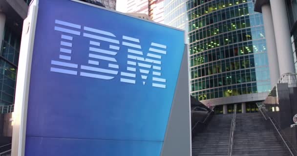 Tablero de señalización con logotipo de IBM. Rascacielos moderno centro de oficina y escaleras de fondo. Representación editorial 4K 3D — Vídeos de Stock