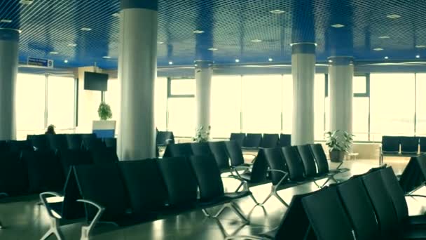 Airport lounge with emty seats and decorated Christmas trees. Holidays travel concept. 4K steadicam shot — Stock Video
