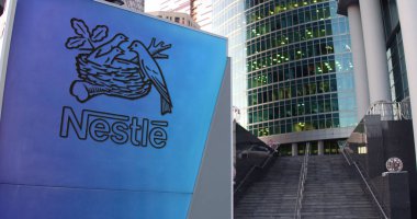 Street signage board with Nestle logo. Modern office center skyscraper and stairs background. Editorial 3D rendering clipart
