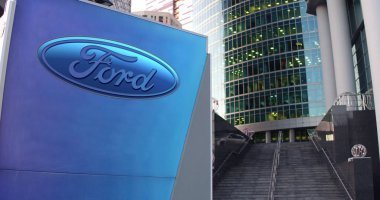 Street signage board with Ford Motor Company logo. Modern office center skyscraper and stairs background. Editorial 3D rendering clipart