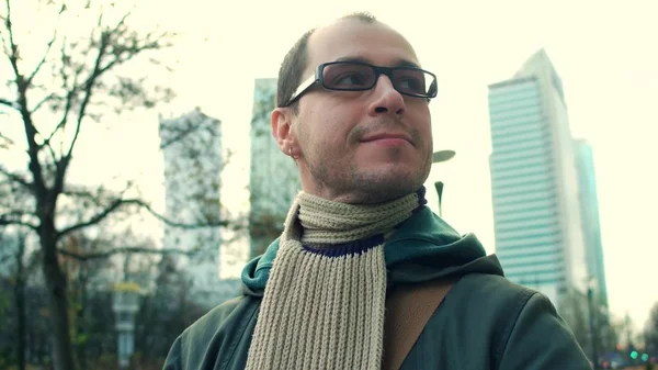 Cheerful programmer wearing black rim glasses walks on city business street — Stock Photo, Image