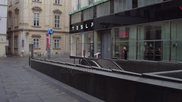 VIENNA, AUSTRIA - DECEMBER, 24 Steadicam shot of parked bicycles, metro station entrance and Tesla electric cars showroom. Ecologic transport concept. 4K video — Stock Video