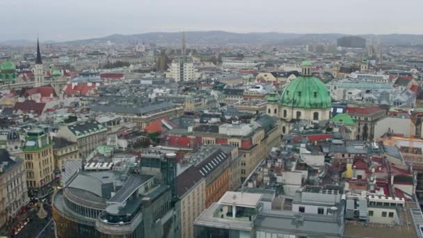 Old low-rise and modern buildings roofs in Vienna on a cloudy day, Austria. 4K overview pan shot — Stock Video