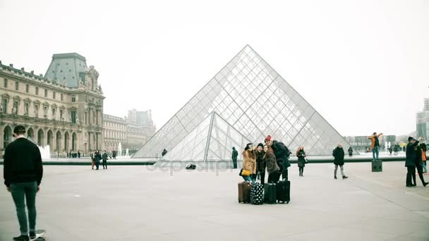Παρίσι, Γαλλία -, στις 31 Δεκεμβρίου 2016. Οι νέοι κάνουν selfie κοντά στο Μουσείο του Λούβρου, διάσημο γαλλικό Μουσείο και δημοφιλή τουριστικό προορισμό. βίντεο 4k — Αρχείο Βίντεο