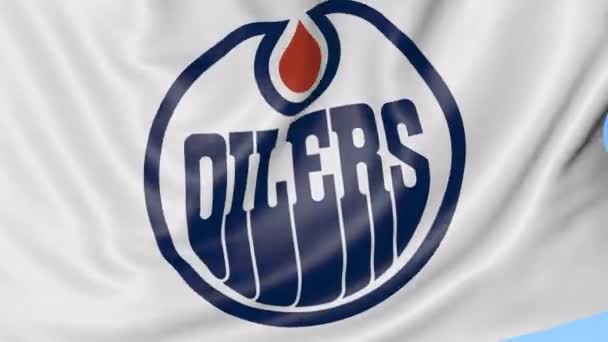 Primer plano de la bandera ondeante con el logotipo del equipo de hockey NHL de Edmonton Oilers, lazo sin costuras, fondo azul. Animación editorial. 4K — Vídeos de Stock