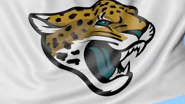 Primo piano della bandiera sventolante con il logo della squadra di football americano dei Jacksonville Jaguars NFL, anello senza cuciture, sfondo blu. Animazione editoriale. 4K — Video Stock
