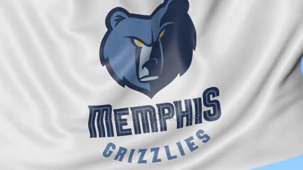 Nahaufnahme einer schwenkenden Flagge mit dem Logo des NBA-Basketballteams der Memphis Grizzlies, nahtloser Schlaufe, blauem Hintergrund. redaktionelle Animation. 4k — Stockvideo