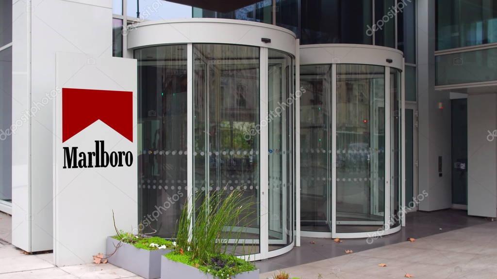 Street signage board with Marlboro logo. Modern office building. Editorial 3D United States
