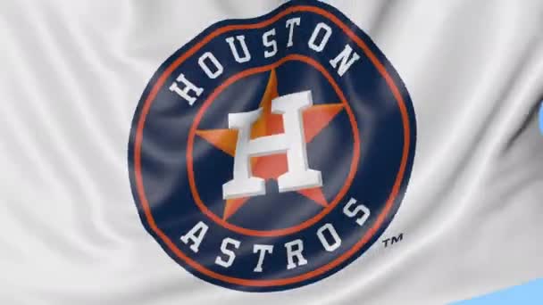Gros plan du drapeau ondulé avec le logo de l'équipe de baseball Houston Astros MLB, boucle transparente, fond bleu. Animation éditoriale. 4K — Video